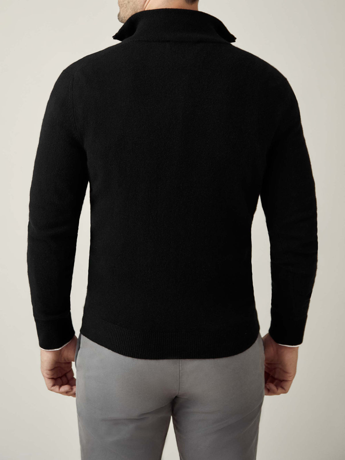 Back view of a model wearing the Luca Faloni black cashmere zip-up.