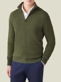 Model wearing Luca Faloni's hunting green cashmere zip-up, styled over a white collared shirt and navy trousers.