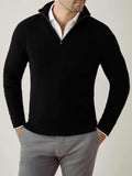 Front view of a model wearing the Black Cashmere Zip-up over a white shirt, with his hands in grey trouser pockets.