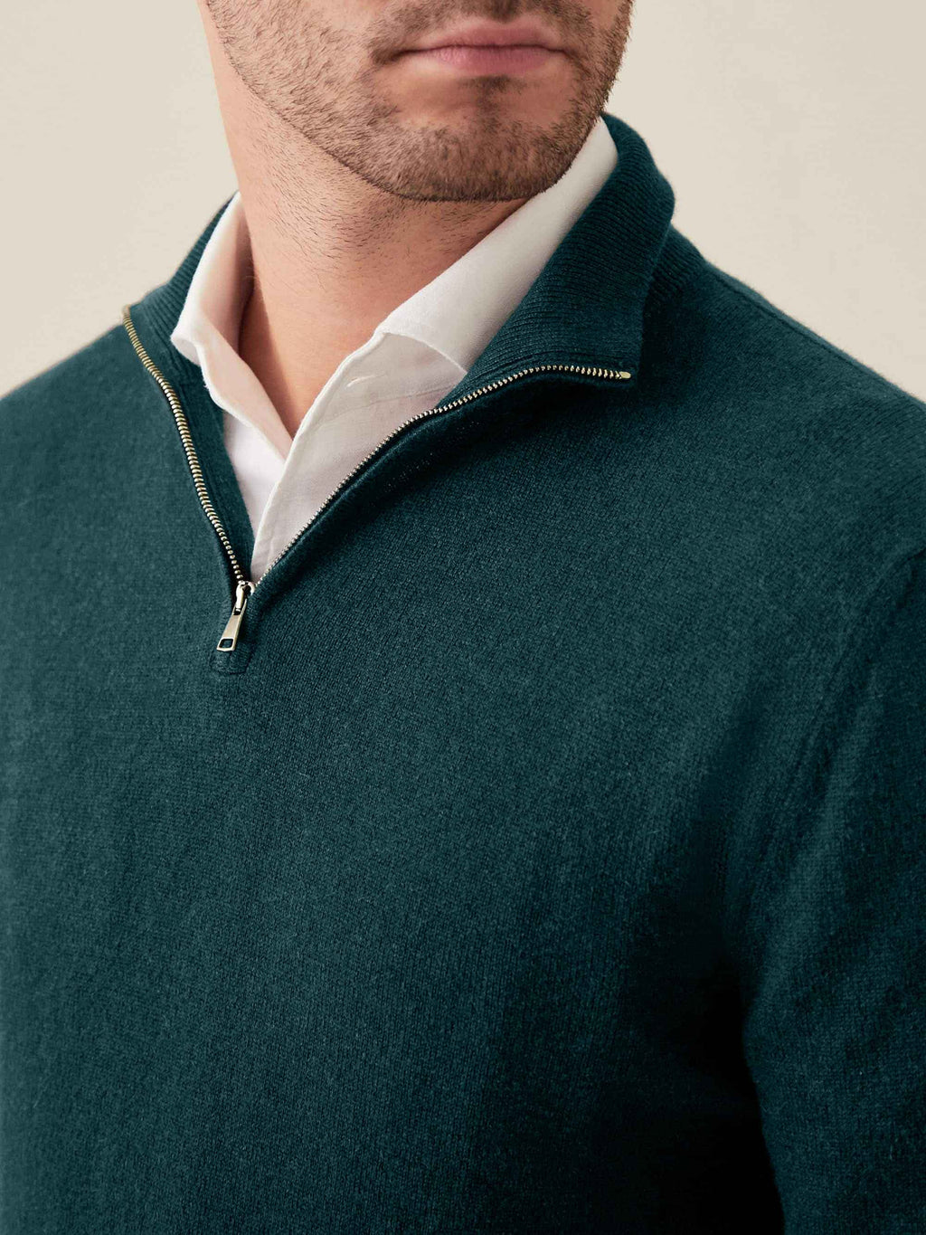 Close-up of a man wearing the Forest Green Cashmere Zip-Up over a white shirt, showing the funnel collar and zip detail.
