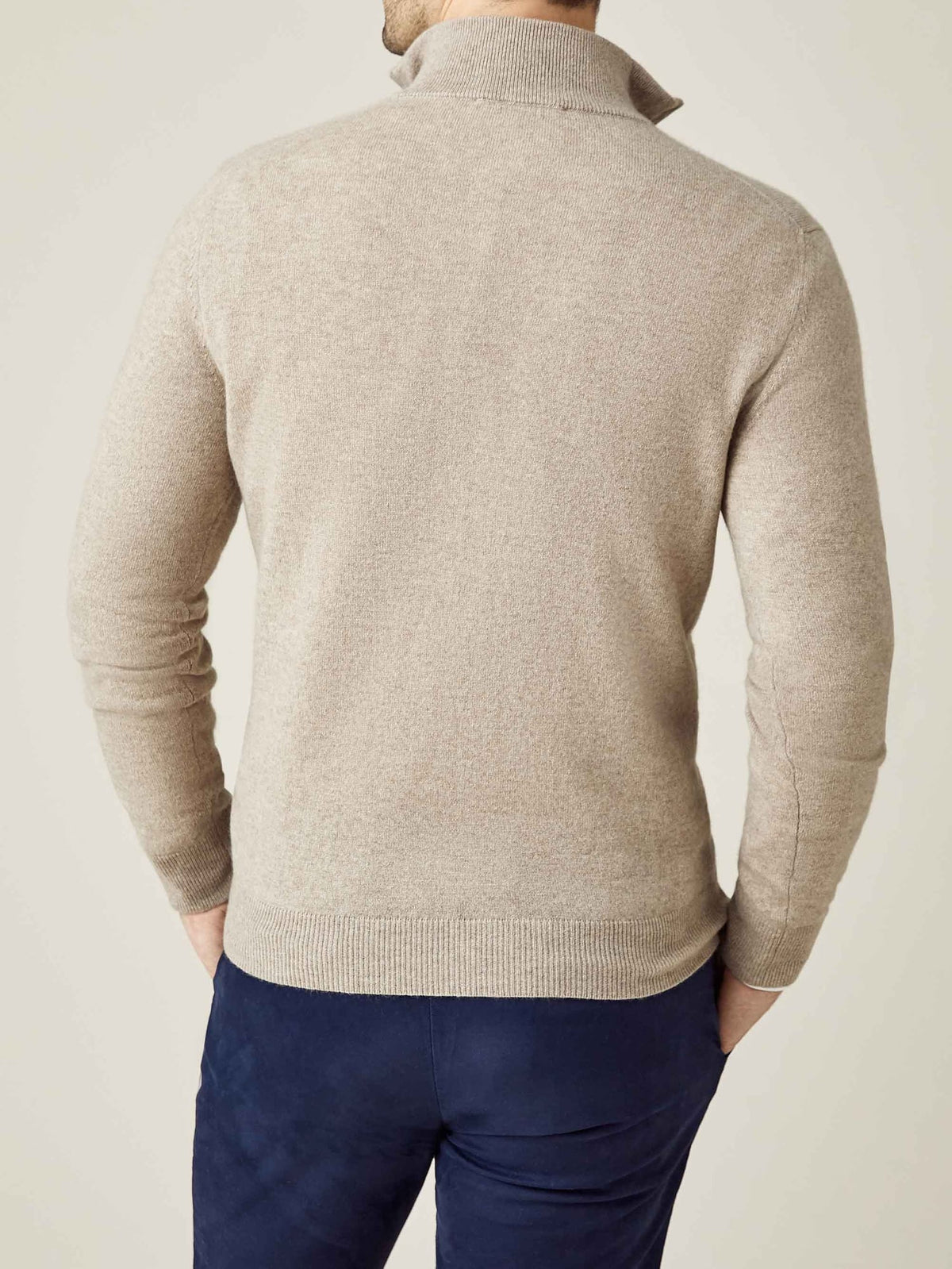 Back view of a model wearing the Luca Faloni Camel Beige Cashmere Zip-up with navy trousers.