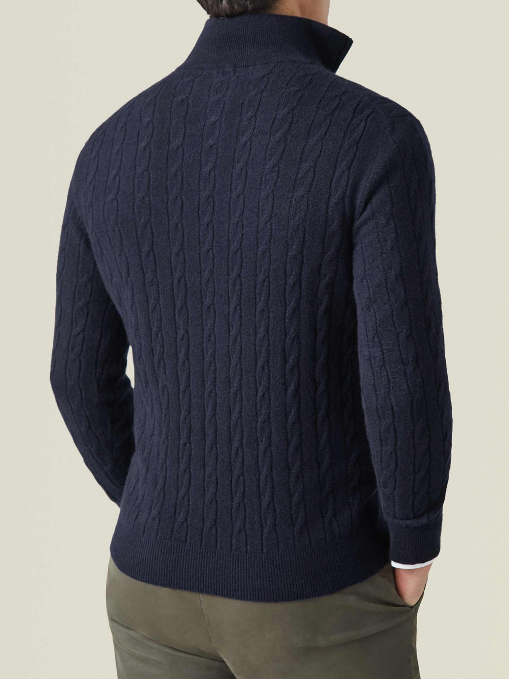 Back view of a man wearing the Midnight Blue Cashmere Cable Knit Zip-up, showing the fit and detailed knit pattern.