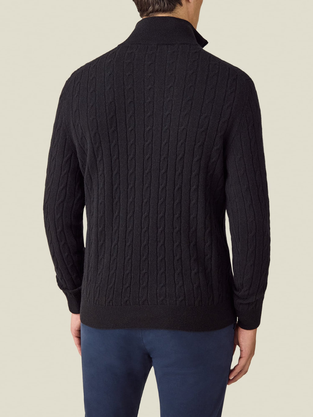 Back view of a model wearing the Luca Faloni Cable Knit Zip-up in black.