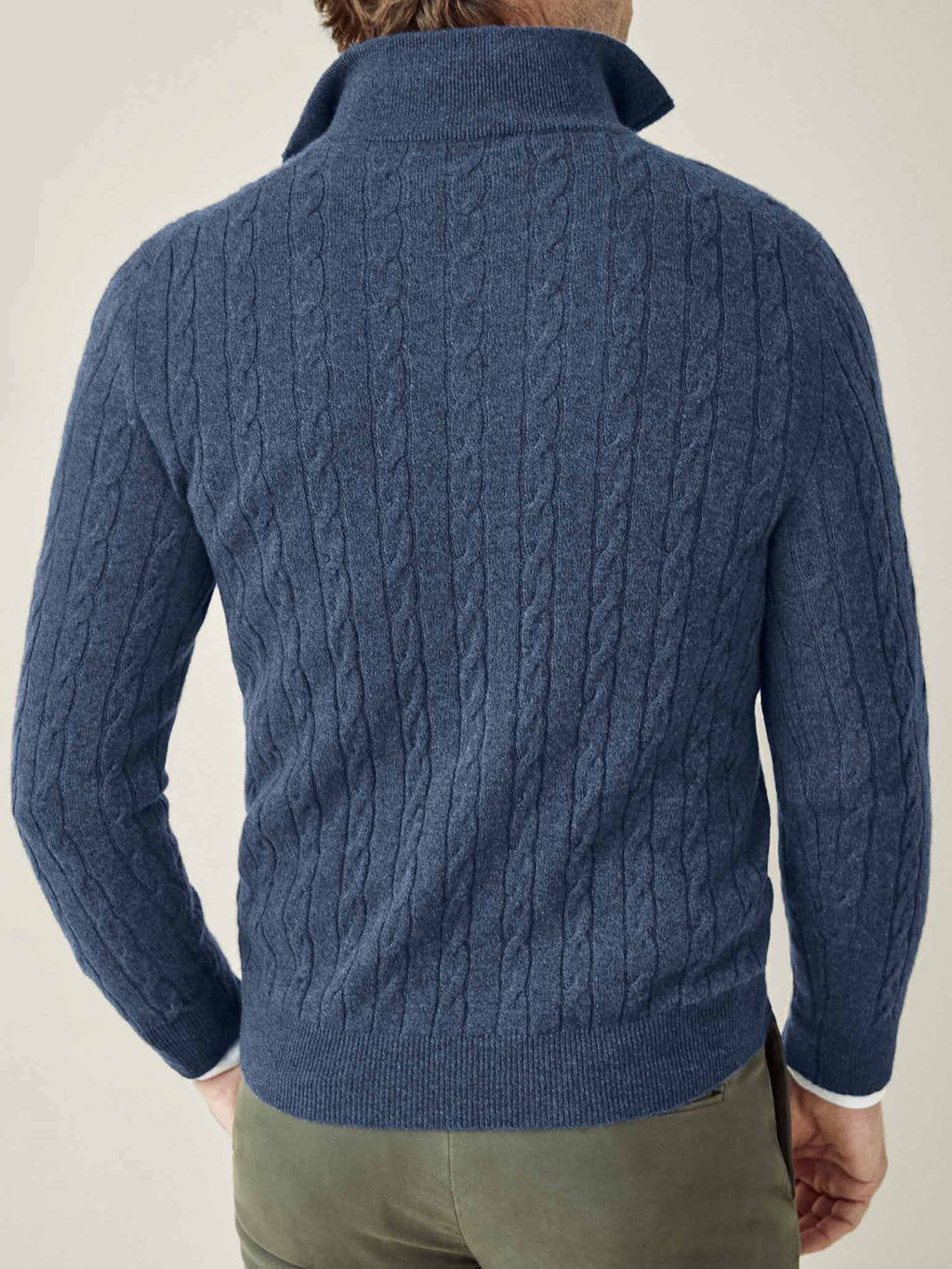 A man seen from behind wearing the Atlantic Blue Cashmere Cable Knit Zip-up, showcasing its detailed texture and fit.