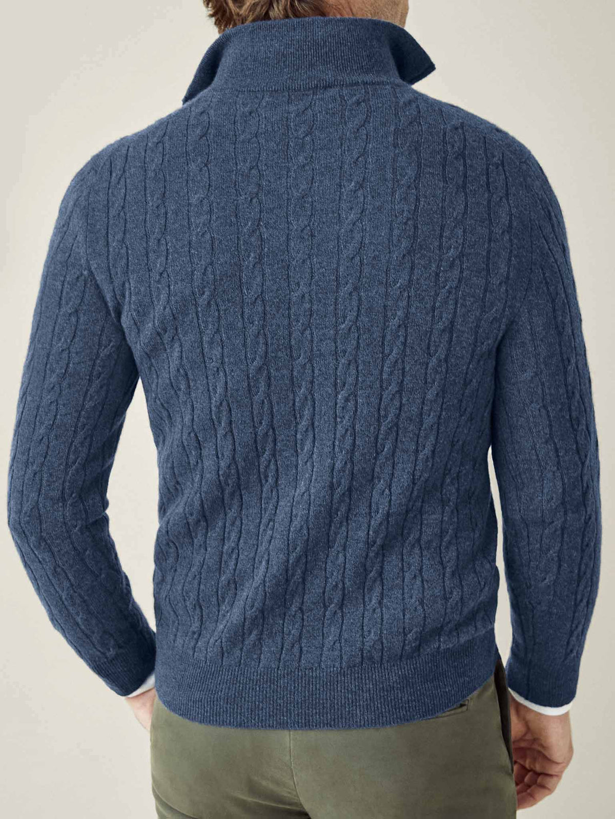 A man seen from behind wearing the Atlantic Blue Cashmere Cable Knit Zip-up, showcasing its detailed texture and fit.