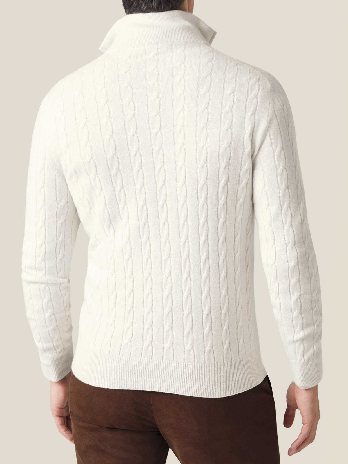 Back view of a model wearing the ivory cashmere Cable Knit Zip-up, showing the detailed pattern and fit.
