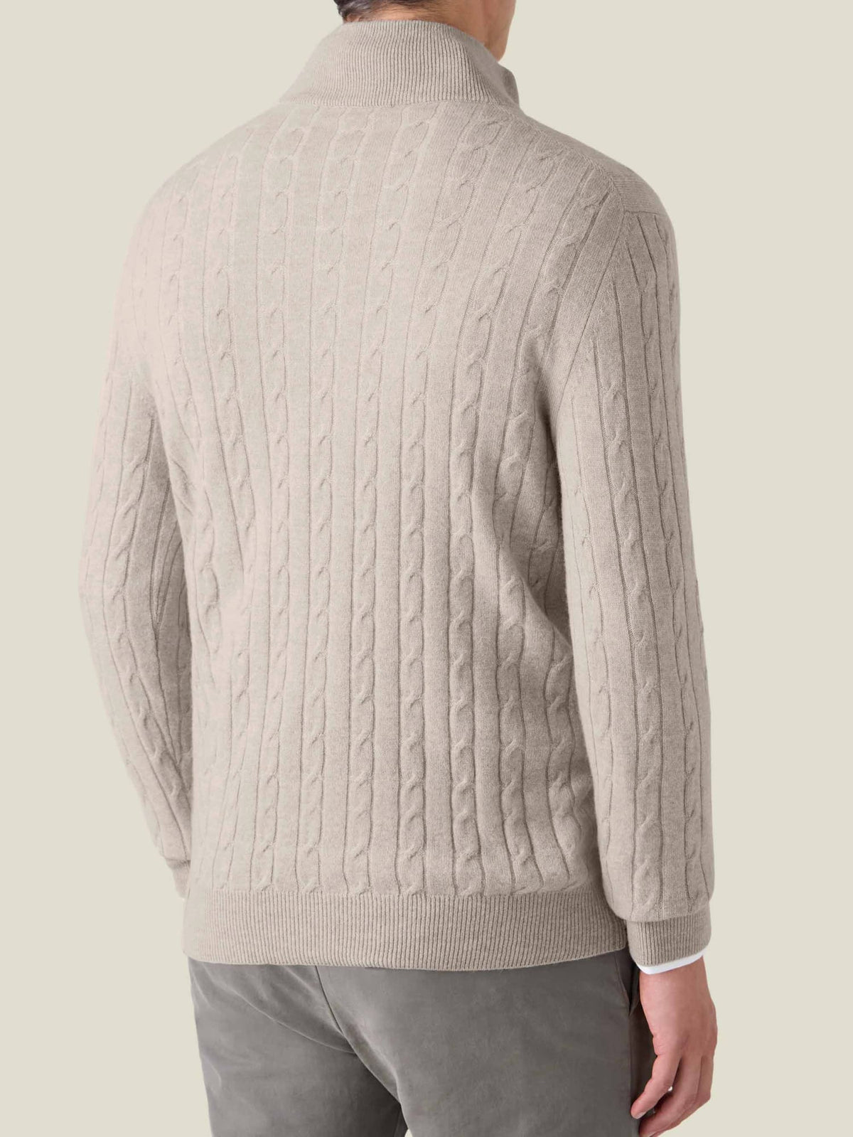 Back view of a model wearing the Luca Faloni Cable Knit Zip-up in almond.