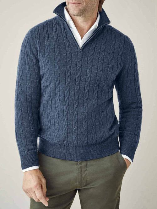 A man wears the Atlantic Blue Cashmere Cable Knit Zip-up, layered over a white shirt, showing the texture and fit.