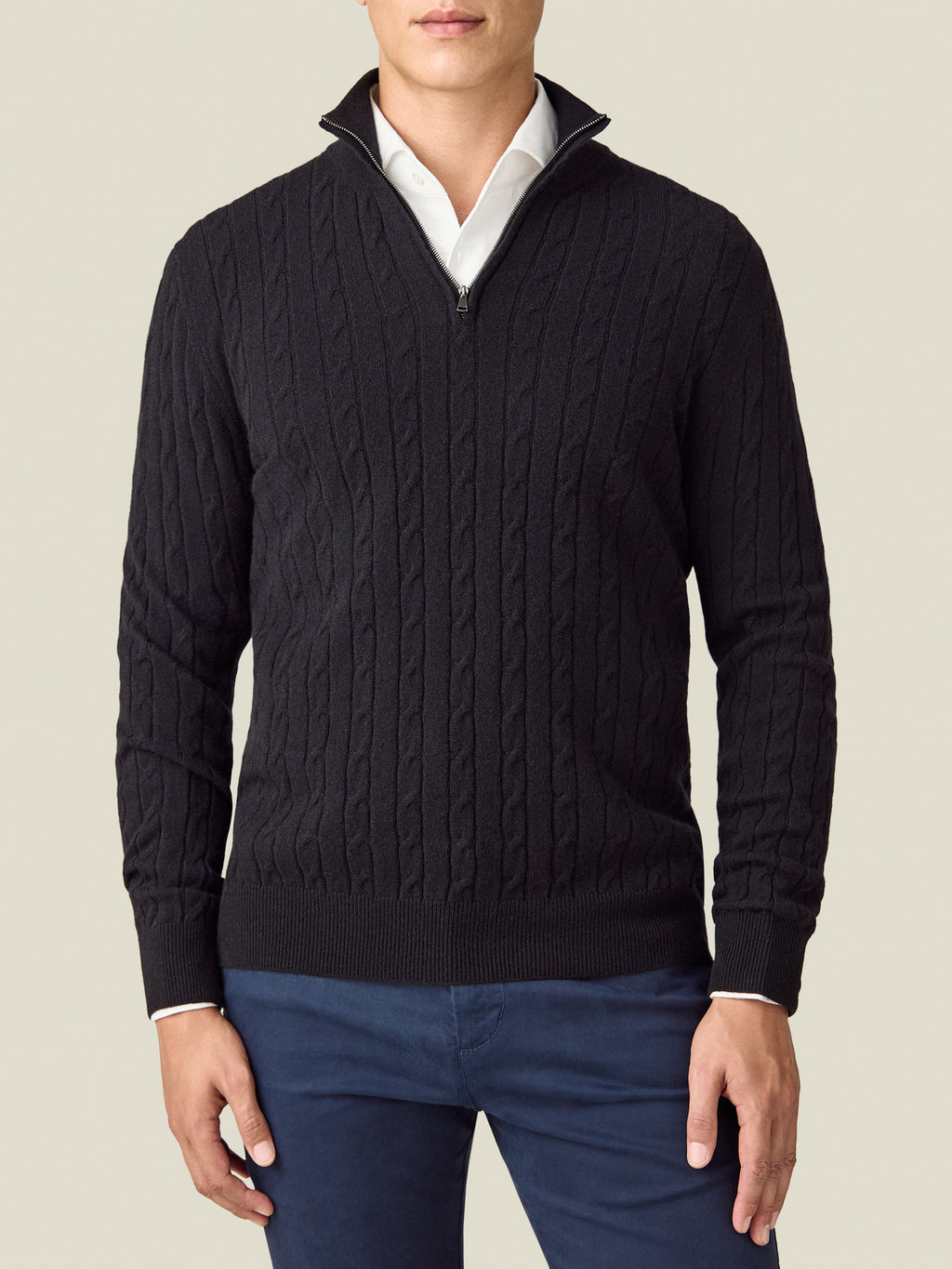 Front view of a model wearing the Luca Faloni Cable Knit Zip-up in black, layered over a white shirt.