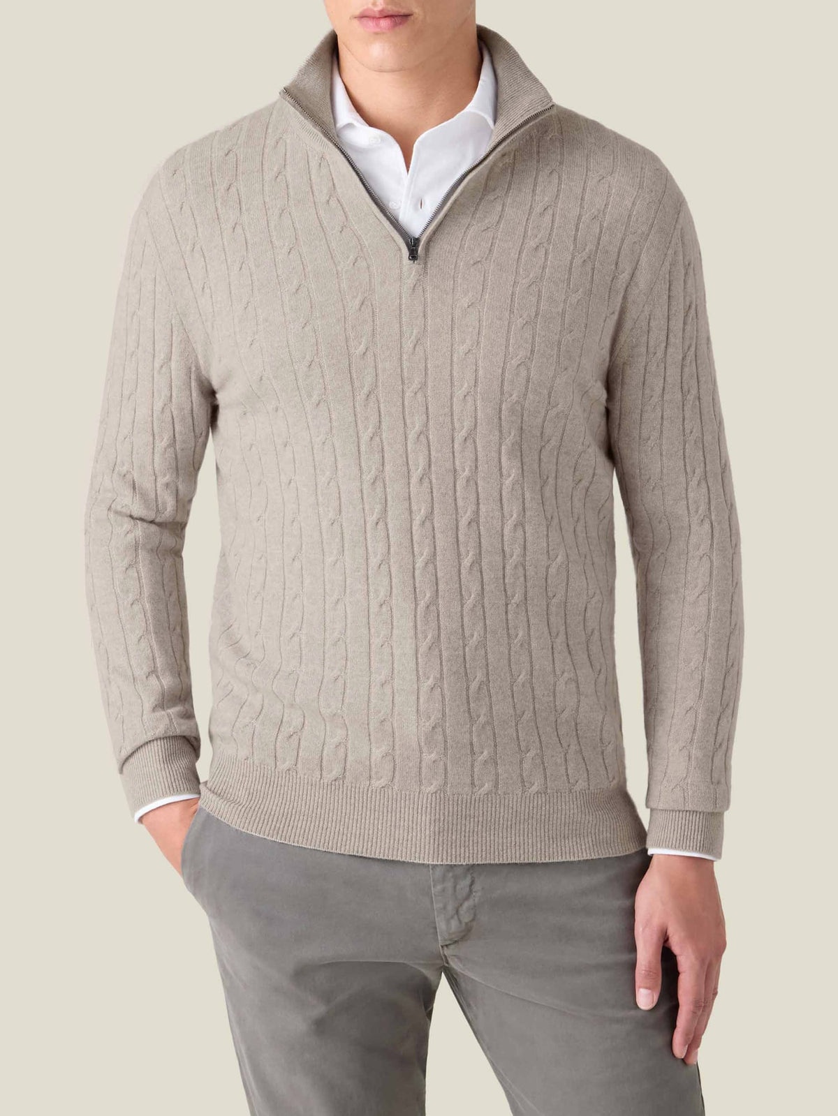 Front view of a model wearing the Luca Faloni Cable Knit Zip-up in almond over a white shirt.