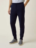 Side view of a model wearing Midnight Blue Cashmere Joggers, styled with a grey t-shirt and grey suede trainers.