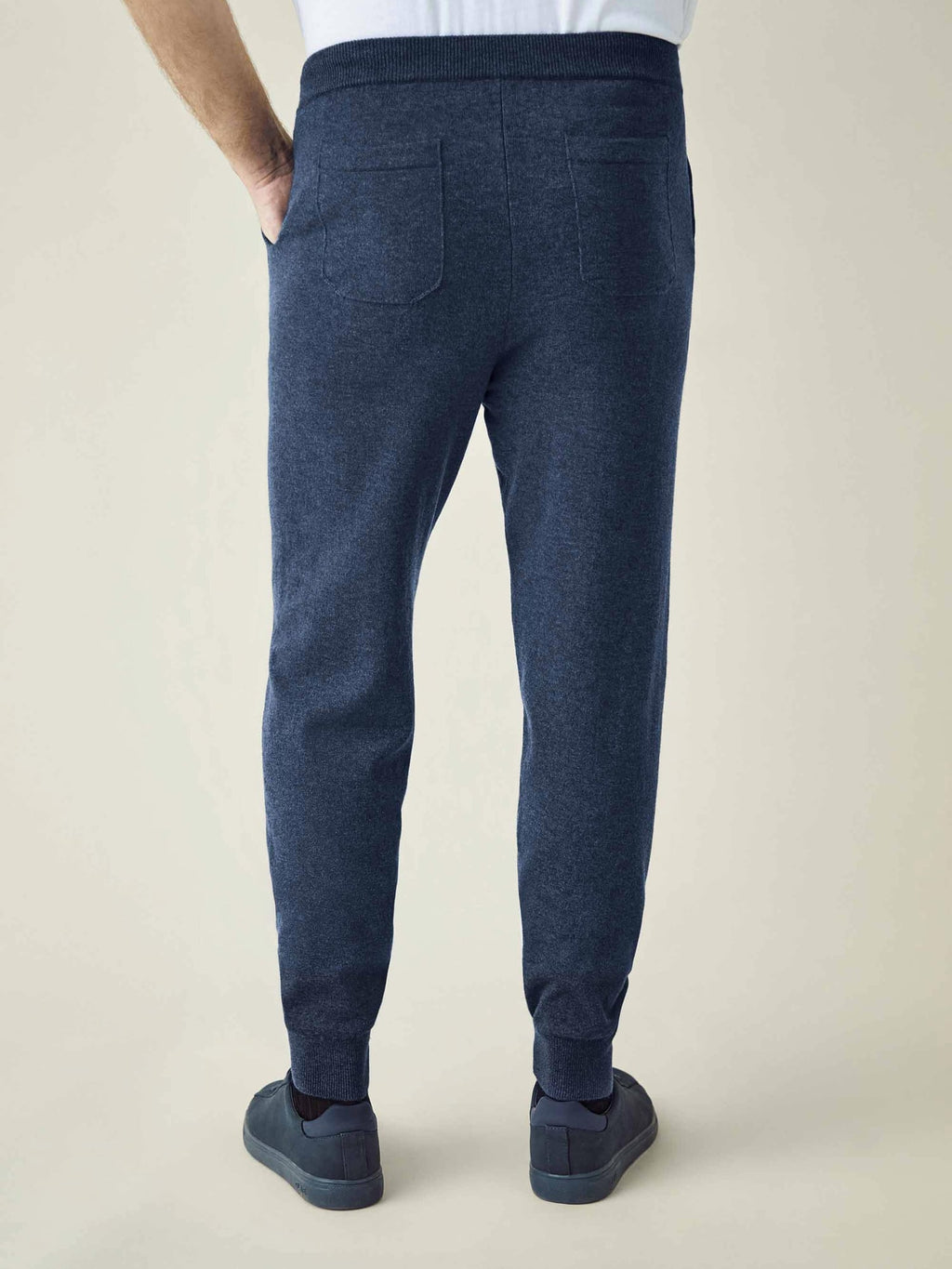 Back view of a man wearing Luca Faloni's Atlantic Blue Cashmere Joggers, showing the relaxed tapered fit and back pockets.