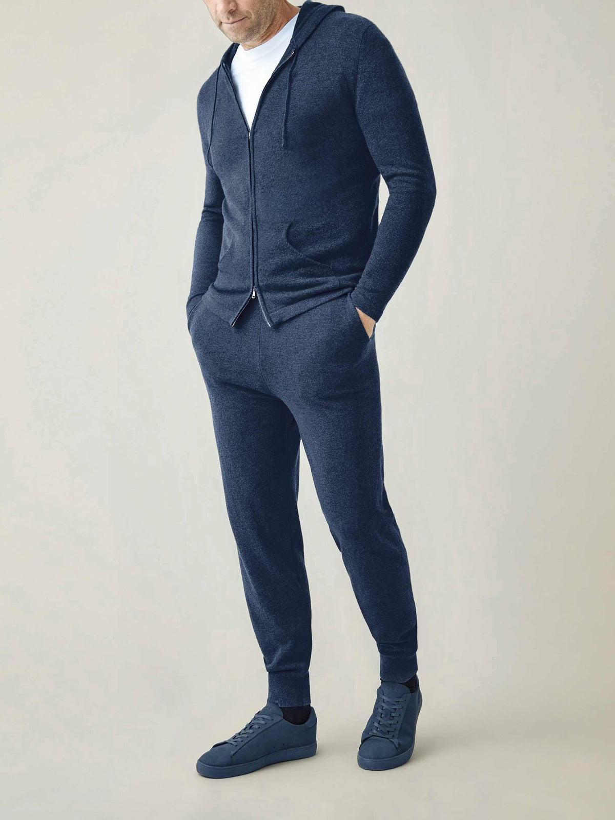 A model showcases the complete Atlantic Blue cashmere loungewear set, featuring the joggers and matching zip hoodie.