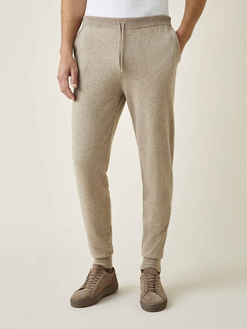 Model wearing the Luca Faloni Cashmere Joggers in Camel Beige. Front view highlighting the tapered fit and drawstring waist.