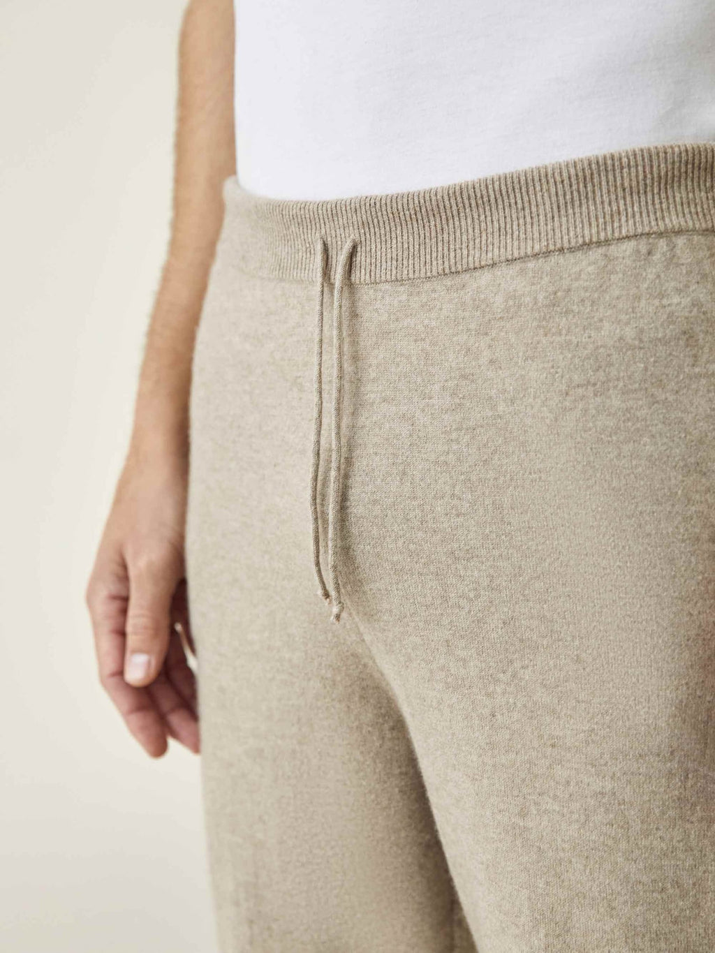 A close-up of the Luca Faloni Camel Beige Cashmere Joggers, highlighting the ribbed waistband and drawstring detail.