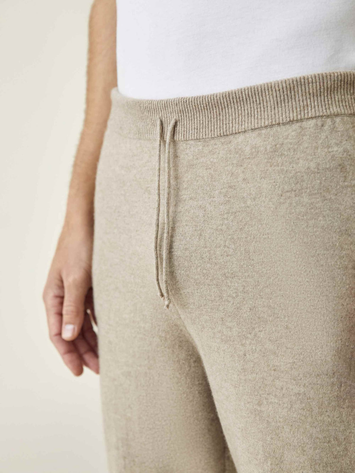 A close-up of the Luca Faloni Camel Beige Cashmere Joggers, highlighting the ribbed waistband and drawstring detail.
