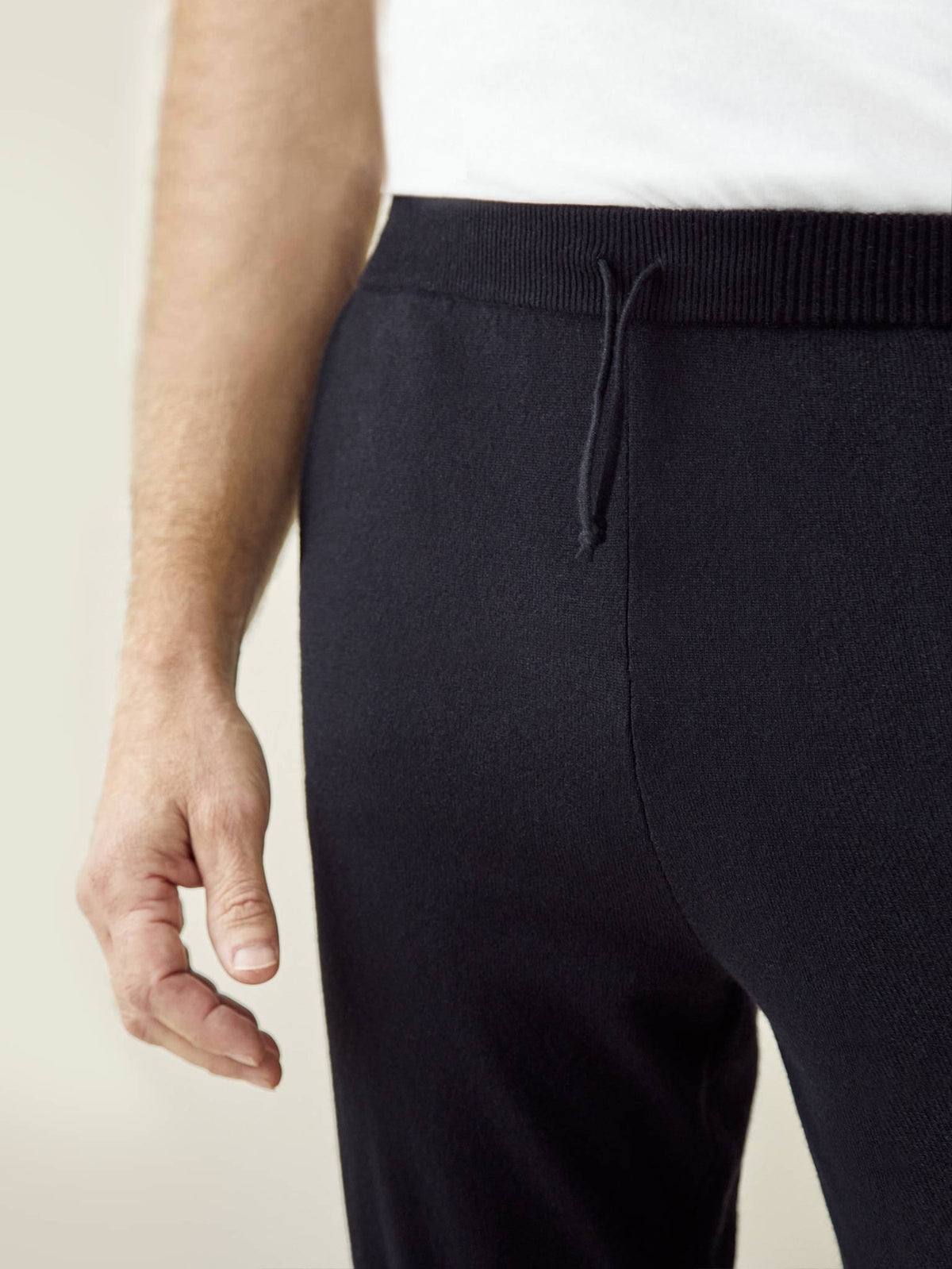 Close-up of the drawstring waist and fine knit texture of the Luca Faloni black cashmere joggers.