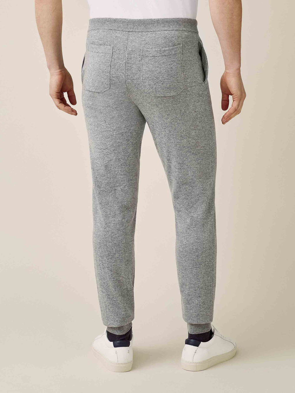 Back view of a model wearing Luca Faloni's Dolomiti Grey Cashmere Joggers, showing the tapered fit and back pockets.