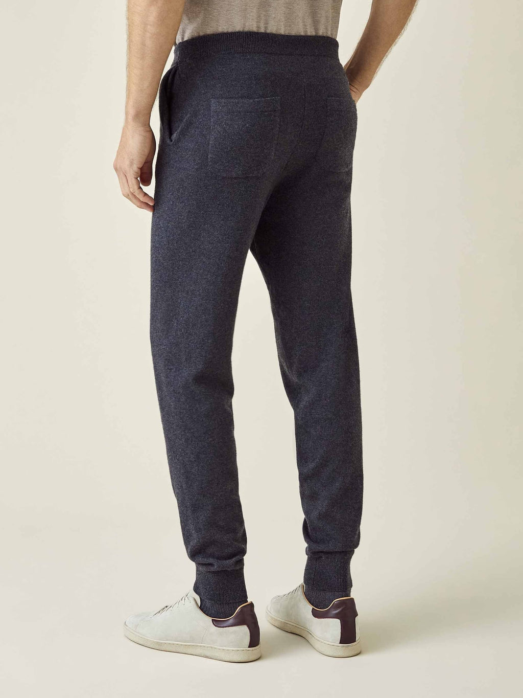 Back view of a model wearing the Luca Faloni Charcoal Grey Cashmere Joggers, showcasing the fit and back pocket.