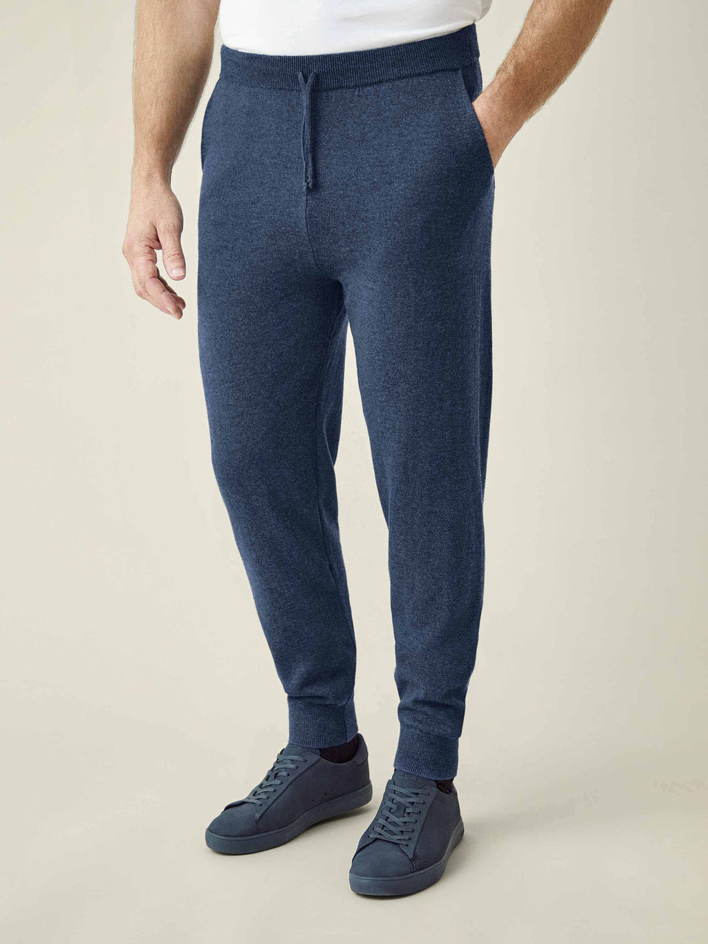 A model wearing Atlantic Blue Cashmere Joggers, showcasing the tapered fit and styled with matching sneakers.