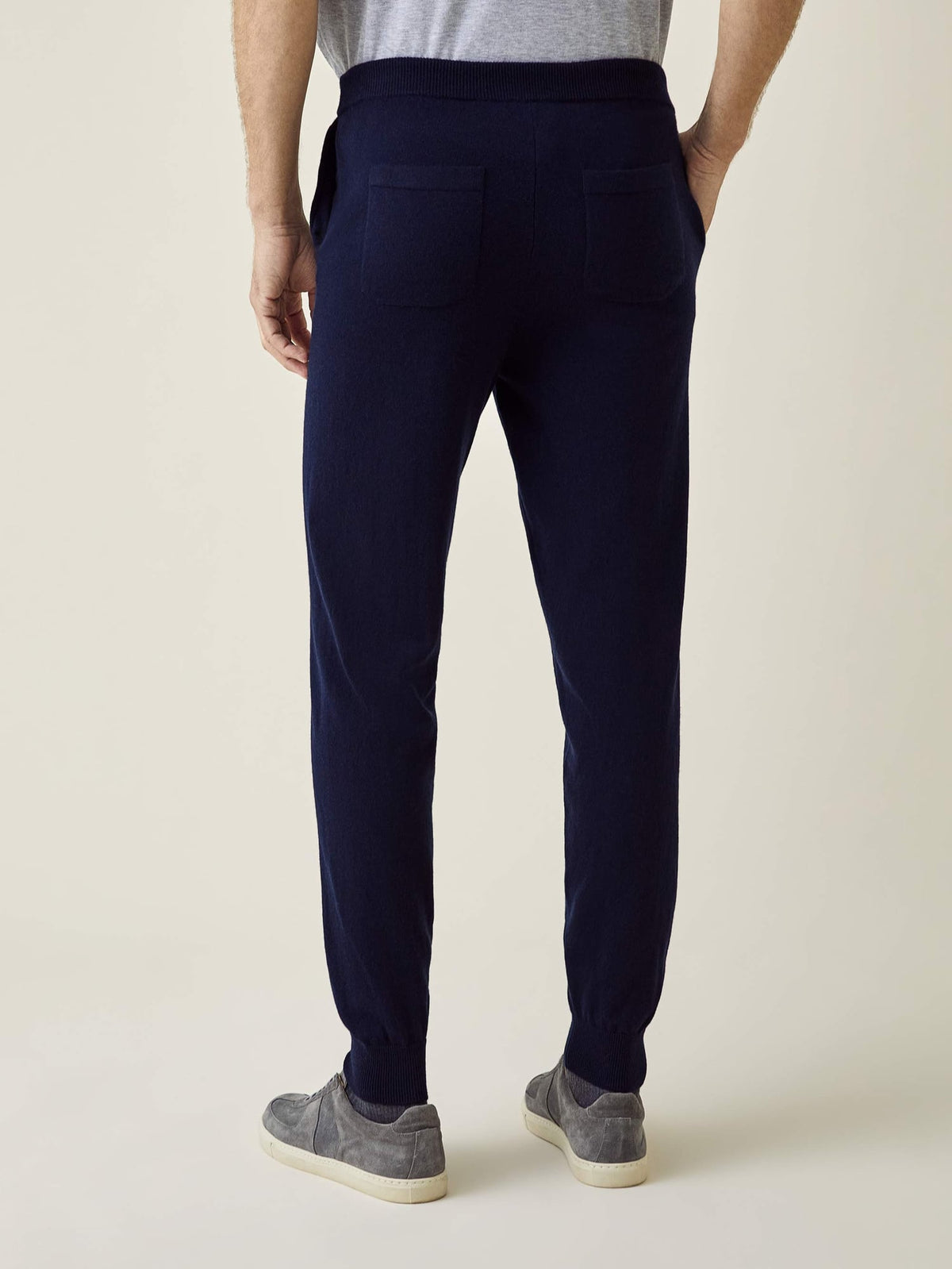 Back view of a man wearing the Midnight Blue Cashmere Joggers, highlighting the tapered fit and dual back pockets.