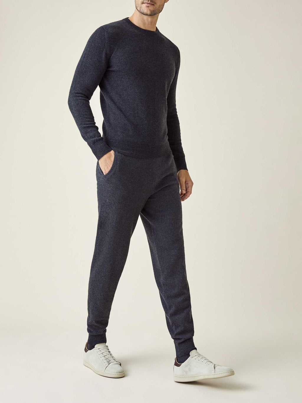 Front view of a model wearing Luca Faloni's charcoal grey cashmere joggers, paired with a matching crew neck sweater.