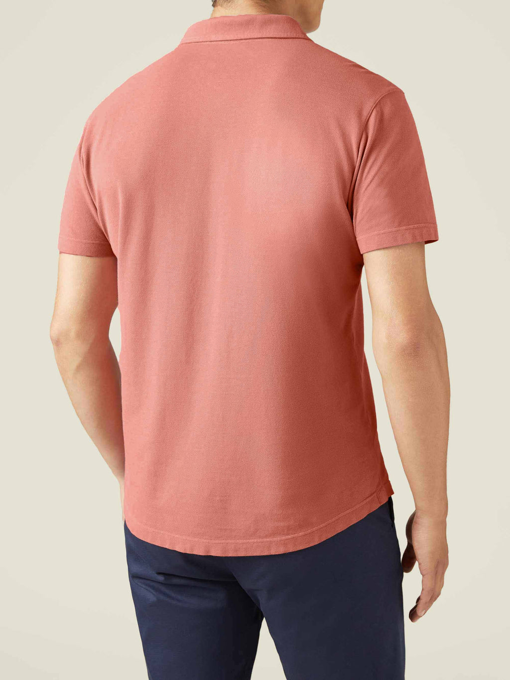 Rear view of a man modelling the Luca Faloni Classic Cotton Piqué Polo in peach.