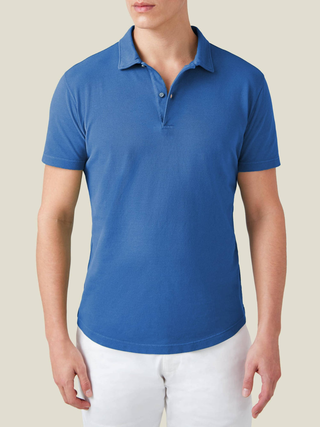Front view of a model wearing the Luca Faloni Classic Piqué Polo in Royal Blue with white trousers.