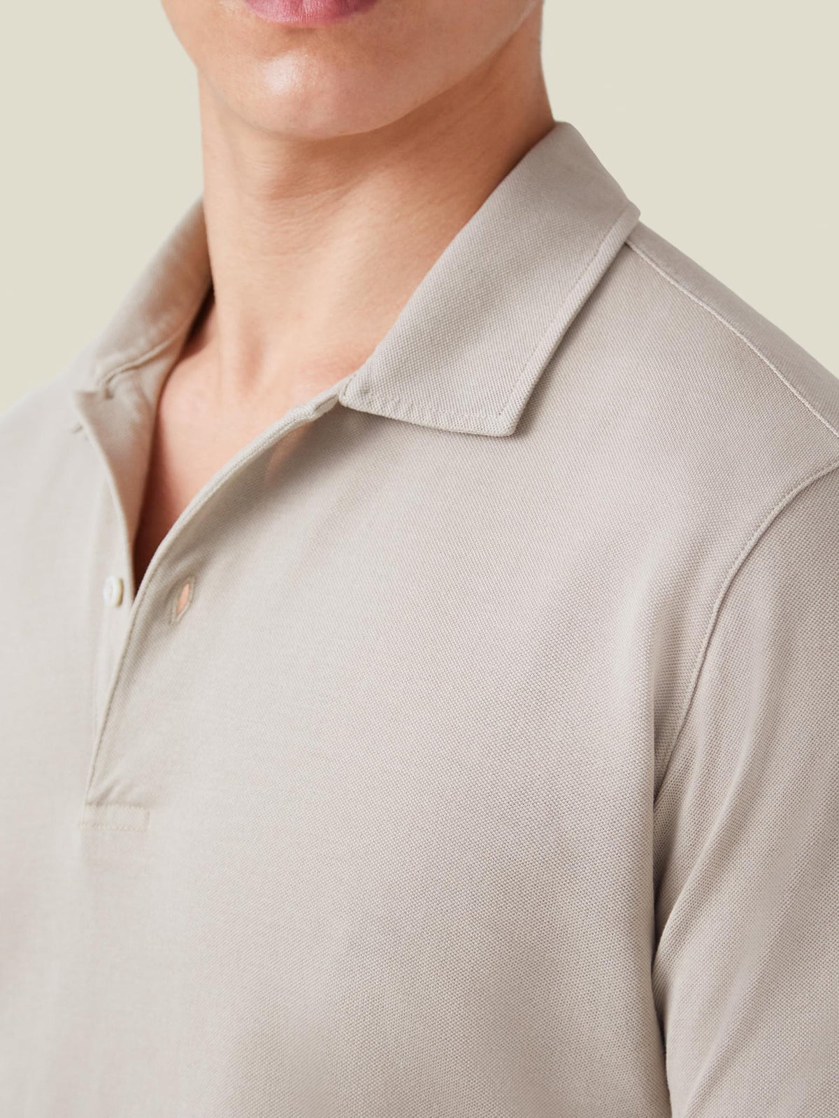 Close-up of the Luca Faloni Classic Piqué Polo in oatmeal, showing the texture of the cotton piqué fabric and collar detail.