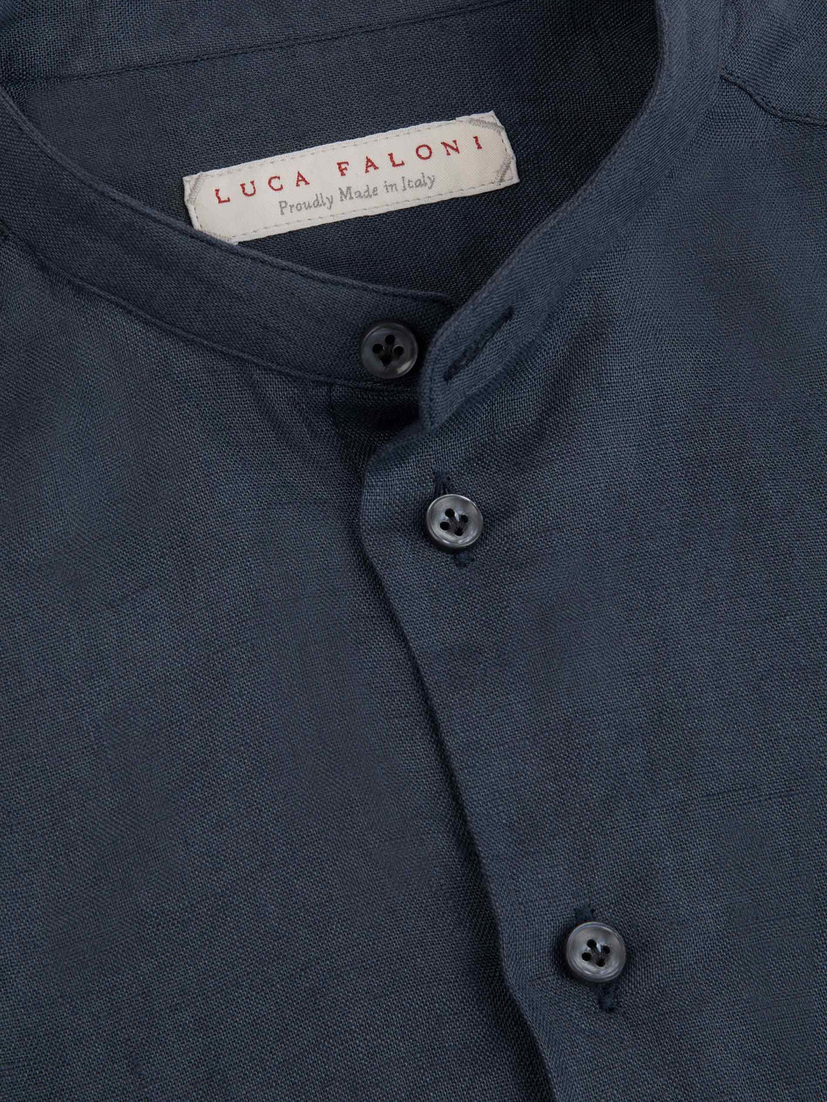 Close-up detail of the Payne's Grey Versilia Junior Linen Shirt, showing the band collar, buttons, and interior brand label.