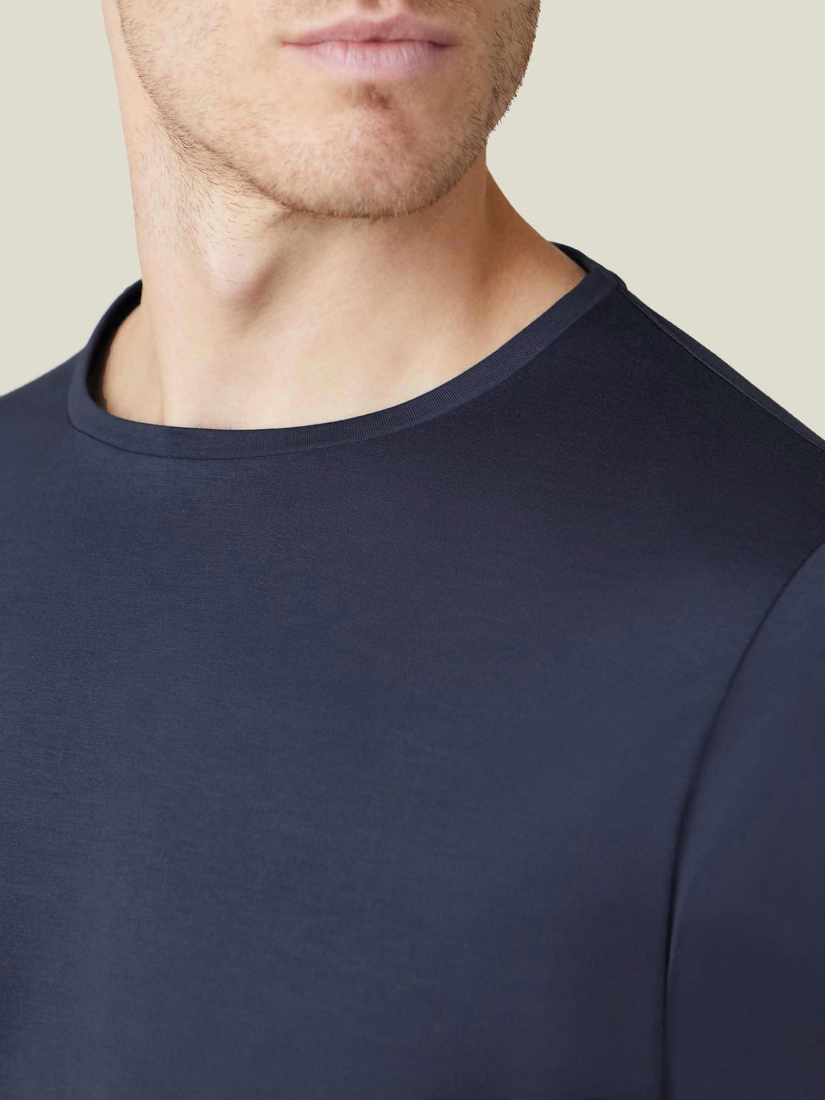 Close-up of the crew neckline and smooth fabric of the Luca Faloni Silk-Cotton Long-Sleeved T-Shirt in Midnight Blue.