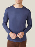 Front view of a model in Luca Faloni's ocean blue silk-cotton long-sleeved t-shirt.