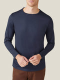 Front view of a model wearing the Luca Faloni Silk-Cotton Long-Sleeved T-Shirt in Midnight Blue with brown trousers.