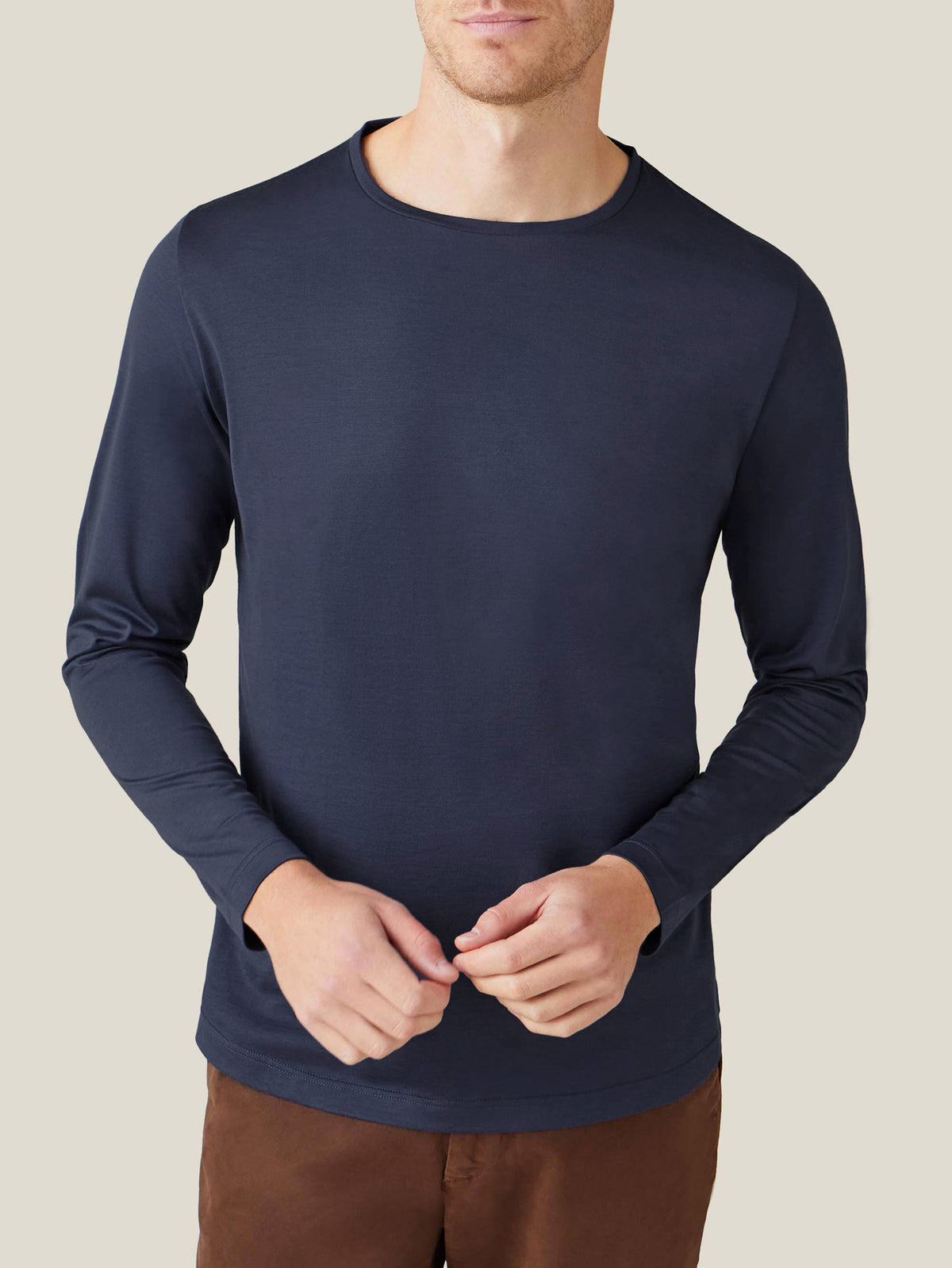 Front view of a model wearing the Luca Faloni Silk-Cotton Long-Sleeved T-Shirt in Midnight Blue with brown trousers.