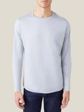 Front view of a man wearing the light grey silk-cotton long-sleeved T-shirt by Luca Faloni.