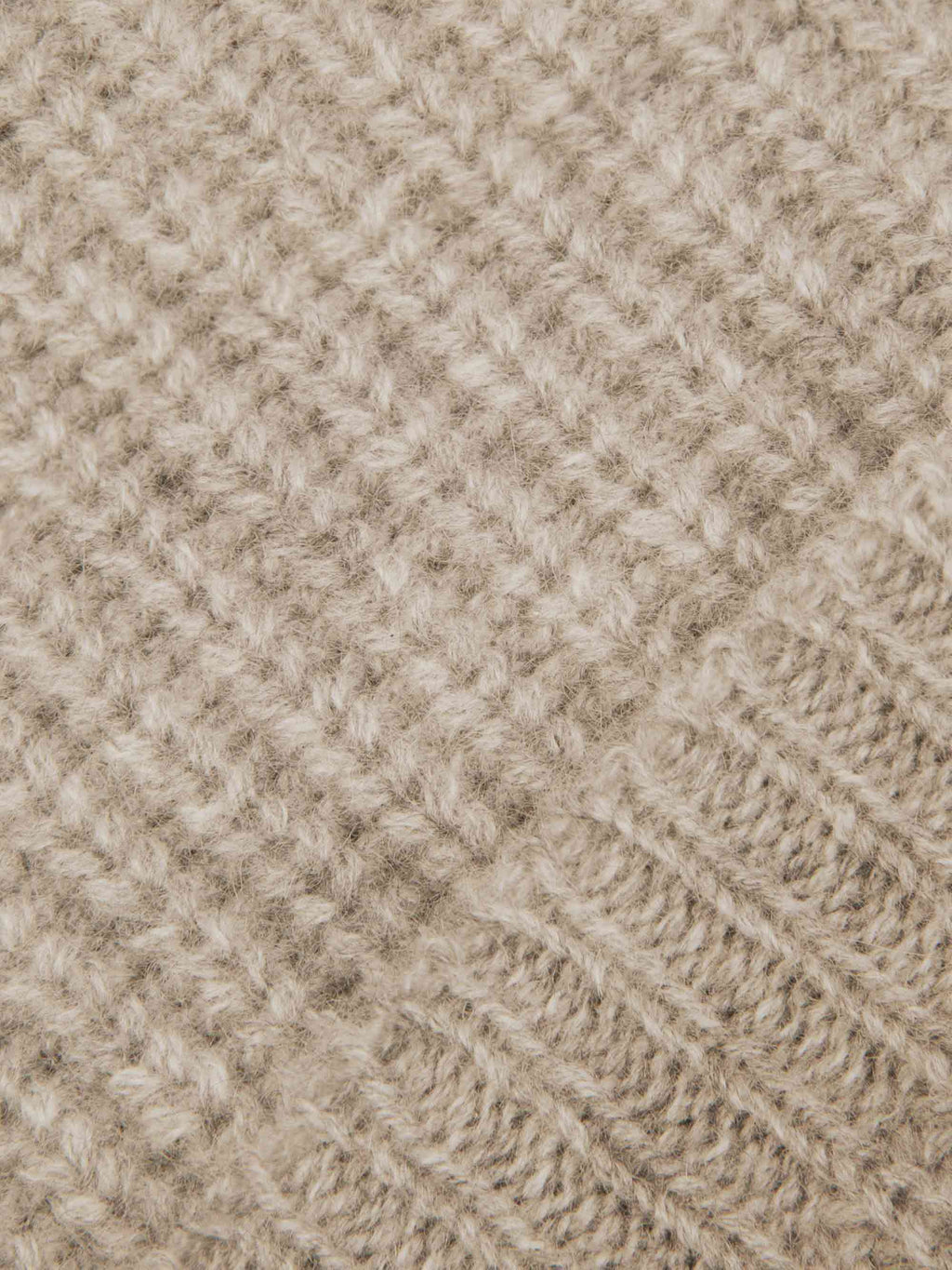 Detailed close-up of the chunky rib-knit texture of Luca Faloni's four-ply cashmere beanie in Camel Beige.