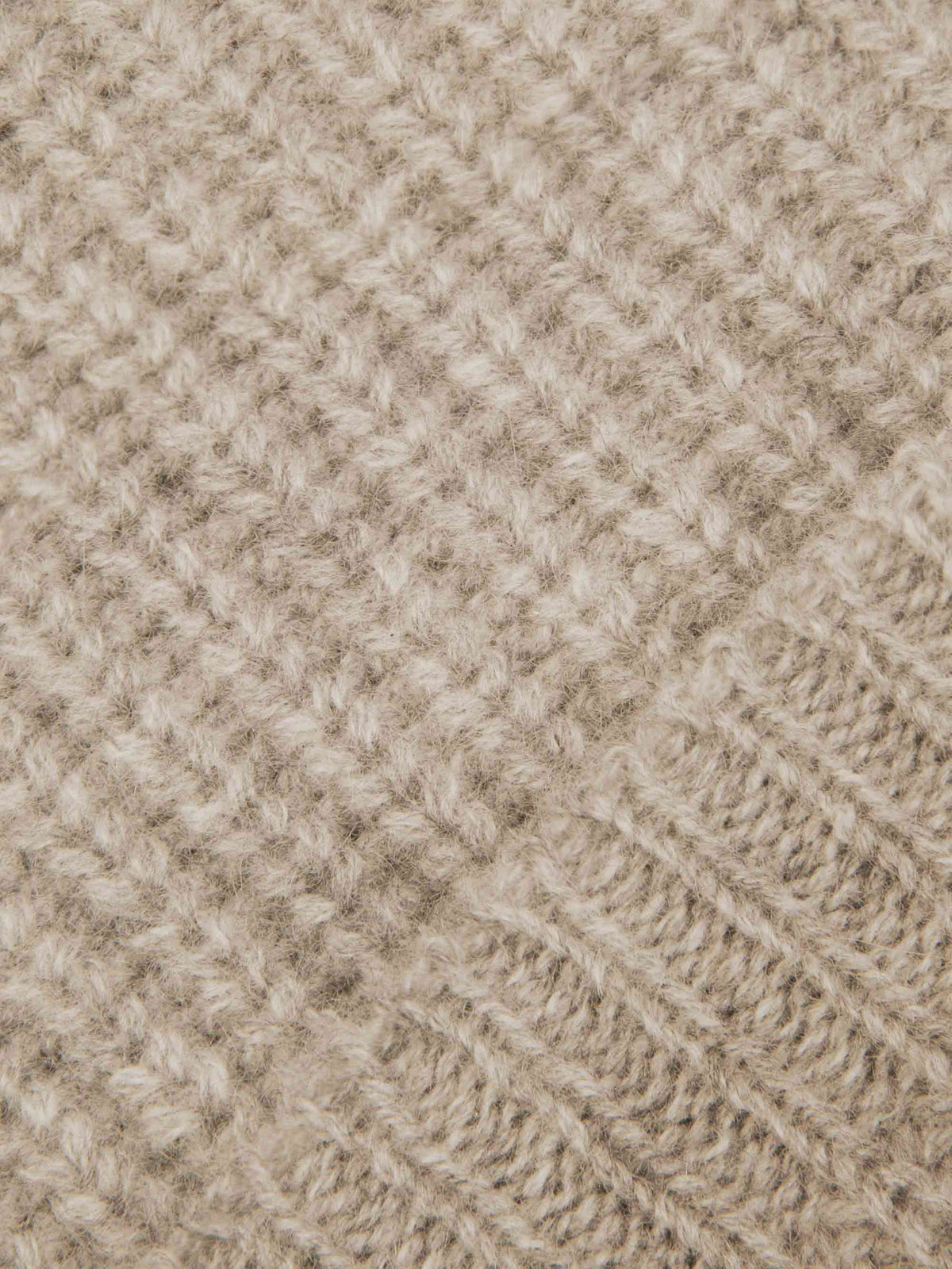 Detailed close-up of the chunky rib-knit texture of Luca Faloni's four-ply cashmere beanie in Camel Beige.