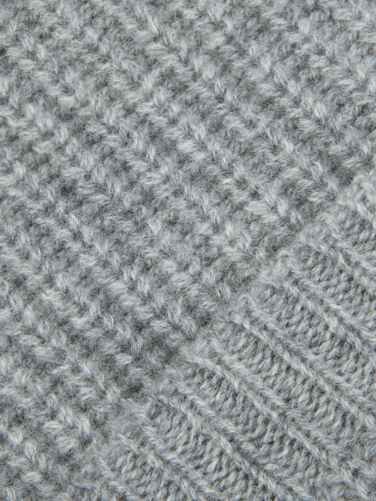 Close-up of the chunky ribbed knit fabric of the Dolomiti Grey cashmere beanie, showing its soft texture.