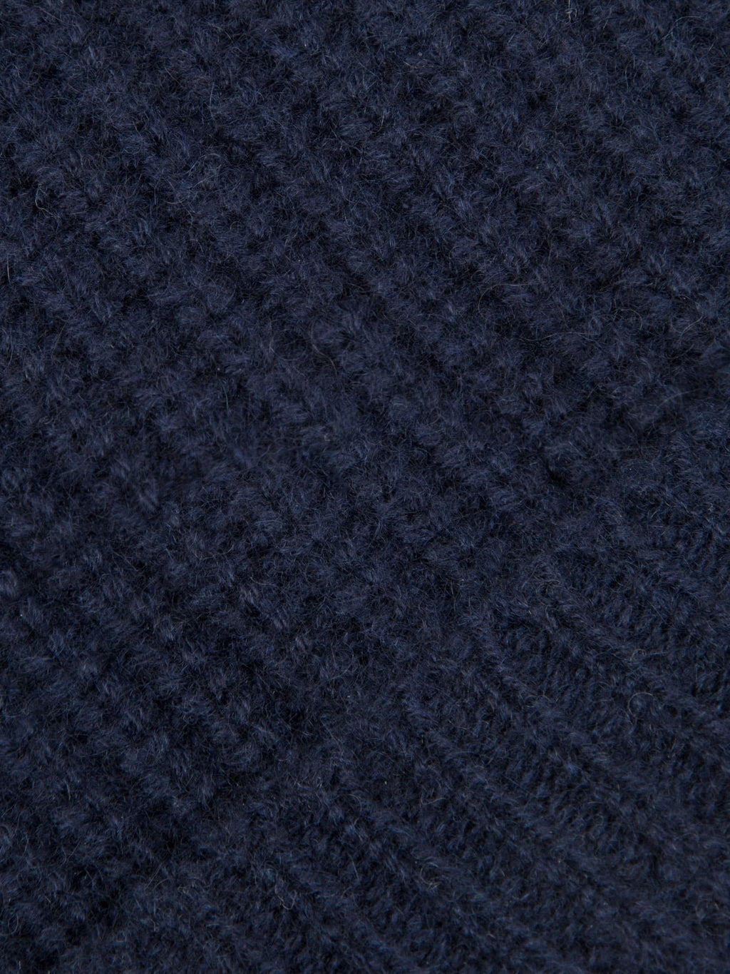 A detailed close-up showcasing the chunky ribbed texture of the Midnight Blue Cashmere Beanie.