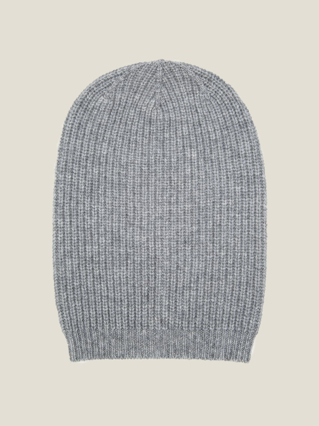 A light grey chunky knit cashmere beanie with a ribbed texture, laid flat against a neutral background.