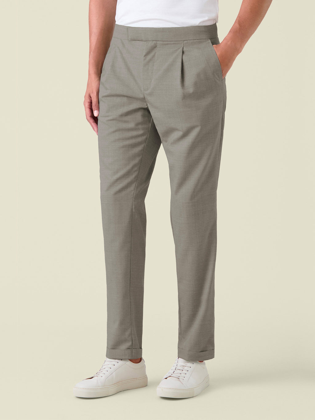 Side view of a model wearing the Camel Beige Lightweight Wool Trousers, showcasing the front pleat and tapered silhouette.
