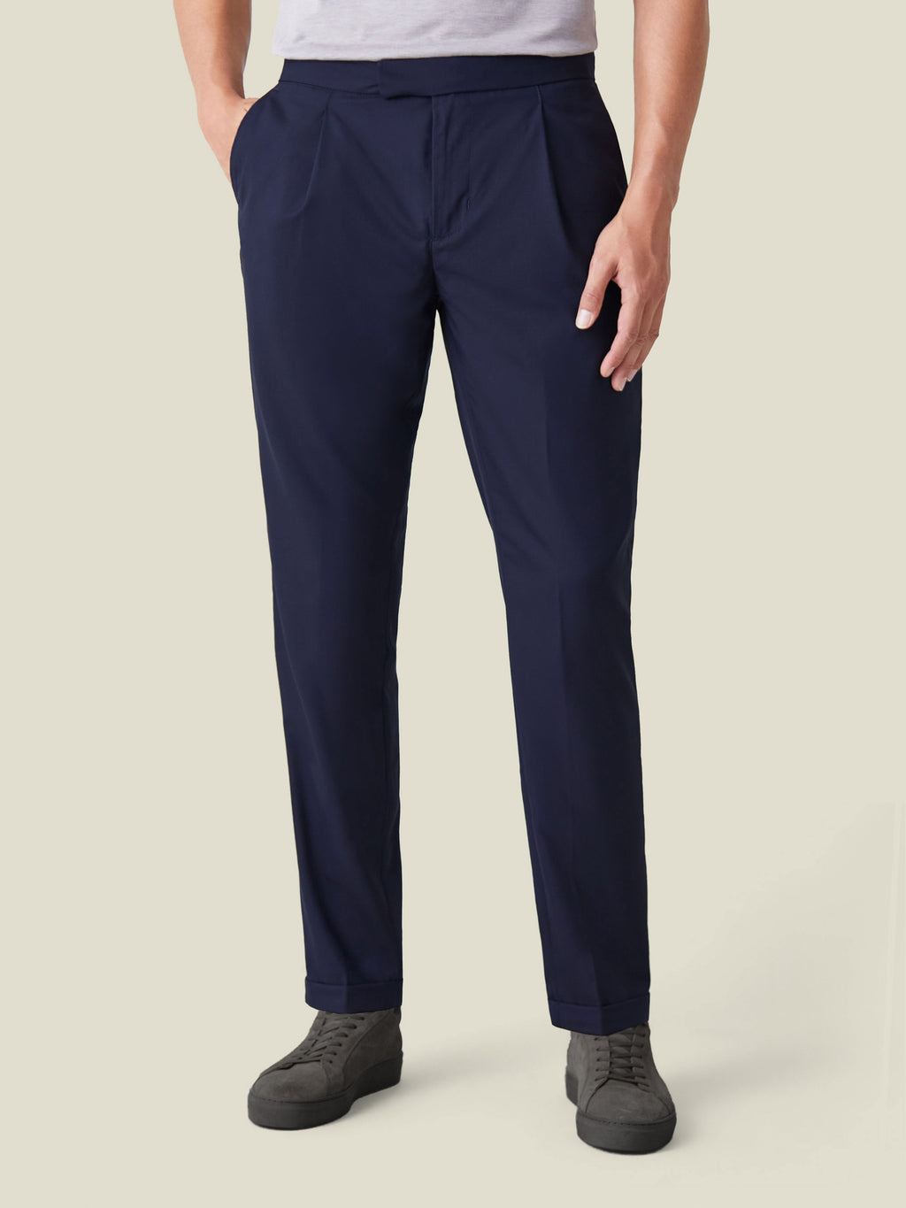 Front view of a model wearing the navy blue Lightweight Wool Trousers, highlighting the single front pleats and tapered fit.
