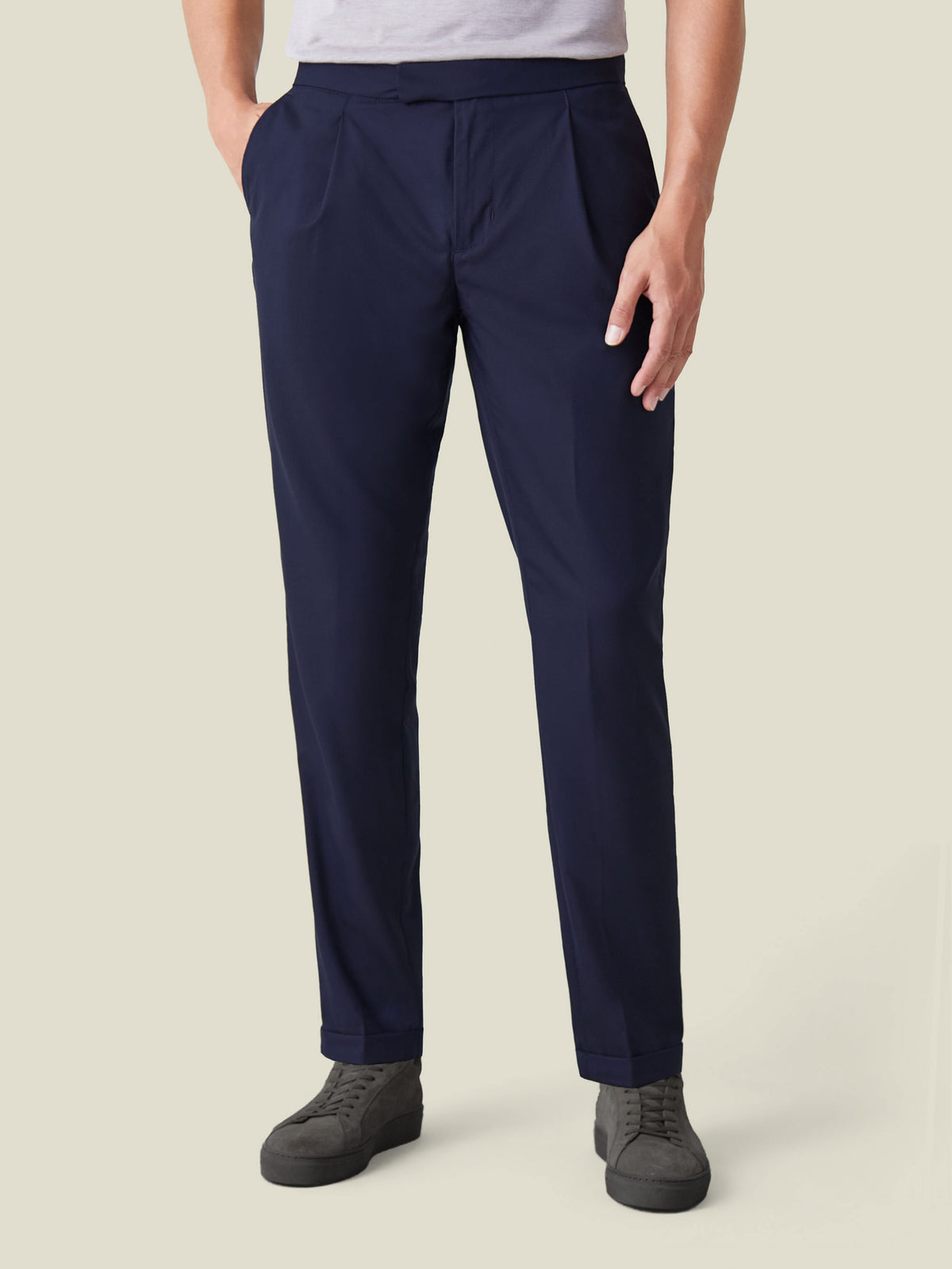 Front view of a model wearing the navy blue Lightweight Wool Trousers, highlighting the single front pleats and tapered fit.