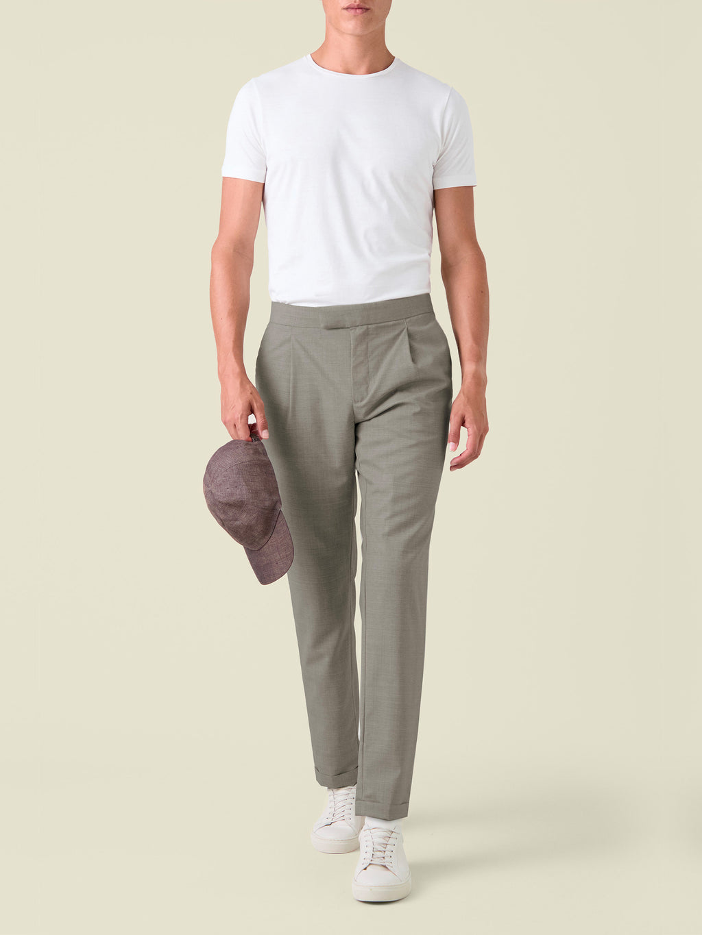 Front view of a model wearing the Camel Beige Lightweight Wool Trousers with a white t-shirt and trainers.