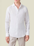 Front view of a model wearing the white Portofino Linen Shirt, highlighting its signature one-piece collar.