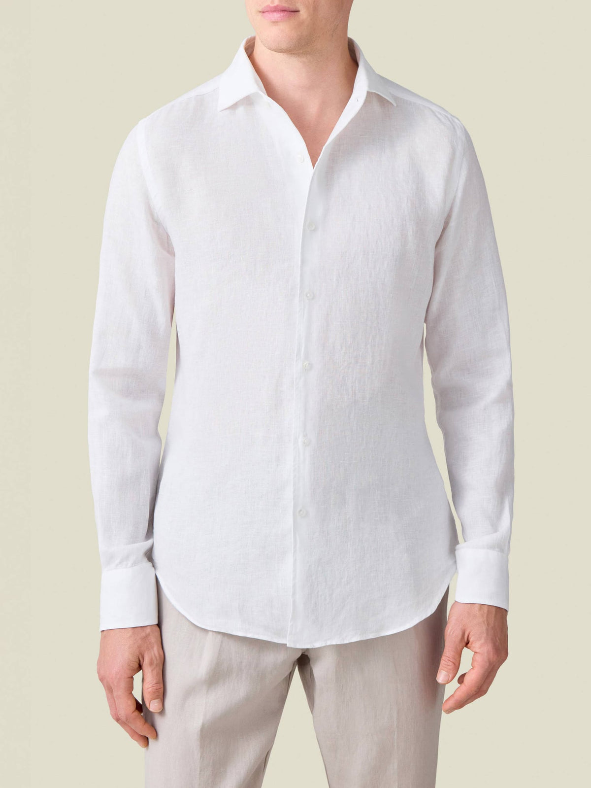 Front view of a model wearing the white Portofino Linen Shirt, highlighting its signature one-piece collar.