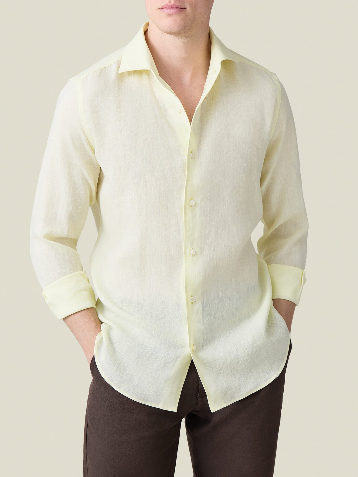 Front view of a model wearing the Portofino Linen Shirt in Lemon, with sleeves rolled up and hands in pockets.