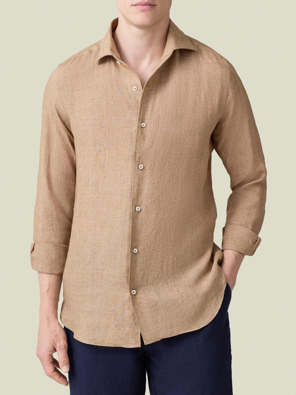 Front view of a model wearing the Portofino Linen Shirt in Caramel Brown with rolled-up sleeves.