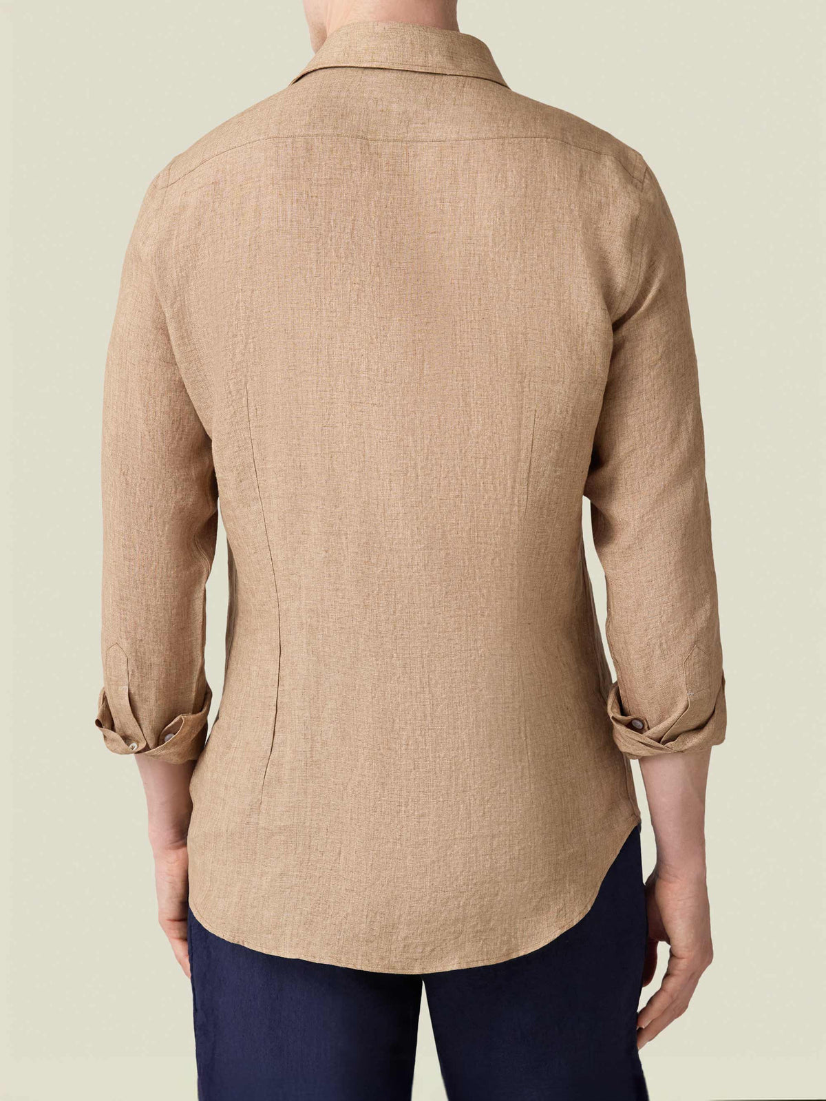 Rear view of a model wearing the Portofino Linen Shirt in Caramel Brown, showcasing its tailored fit and fine linen texture.