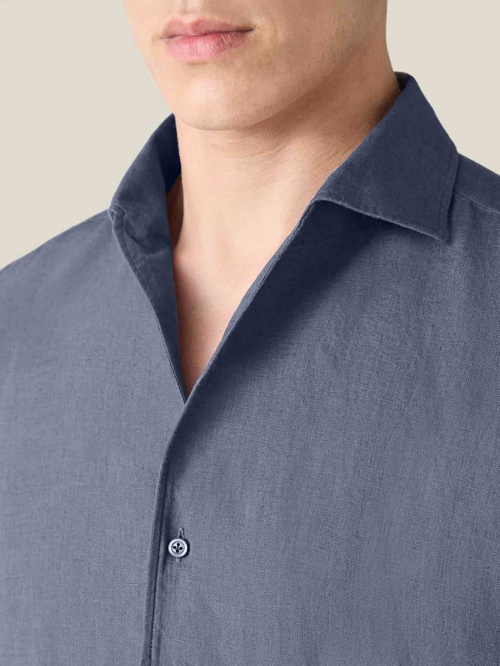 Close-up of a model wearing the Luca Faloni Portofino Linen Shirt in Payne's Grey, showing the one-piece collar detail.